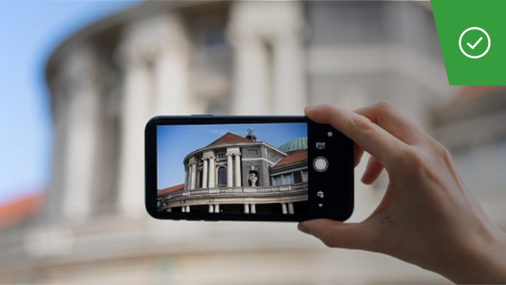 Person taking a photo of  the University’s Main Building with smartphone
