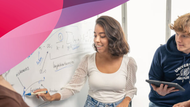People having a discussion in front of a white board
